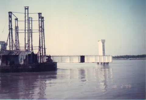 Bridge piers rising from a river, dated February 1999