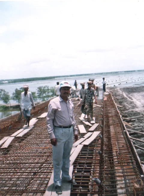 Workers placing steel reinforcement on a deck